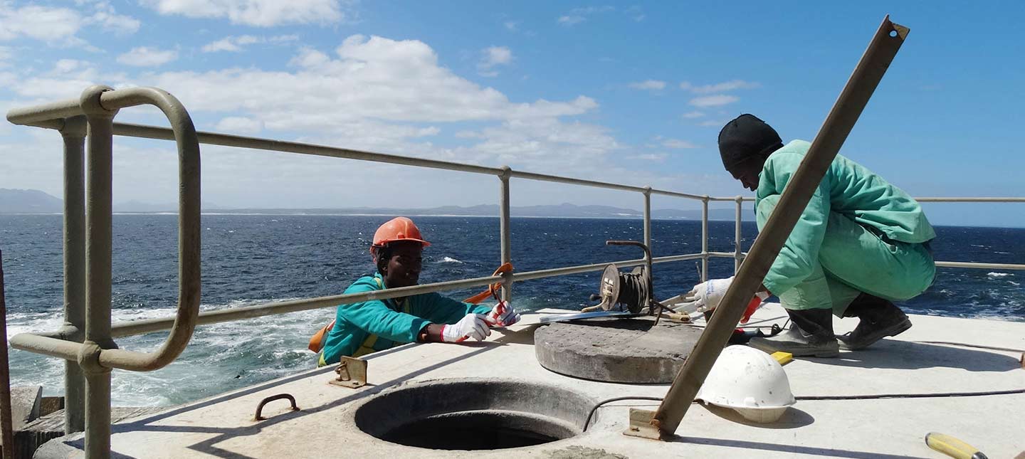 Abagold team members working at the ocean's edge